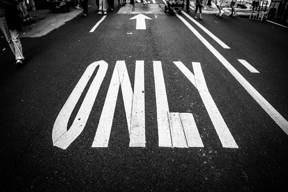 One-way road marking reading ONLY with a straight arrow
