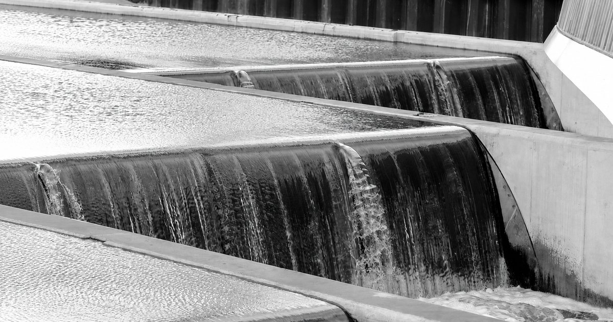 Water cascading over stepped concrete weirs